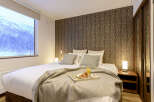 Wake up to breathtaking mountain views from this cozy bedroom.
