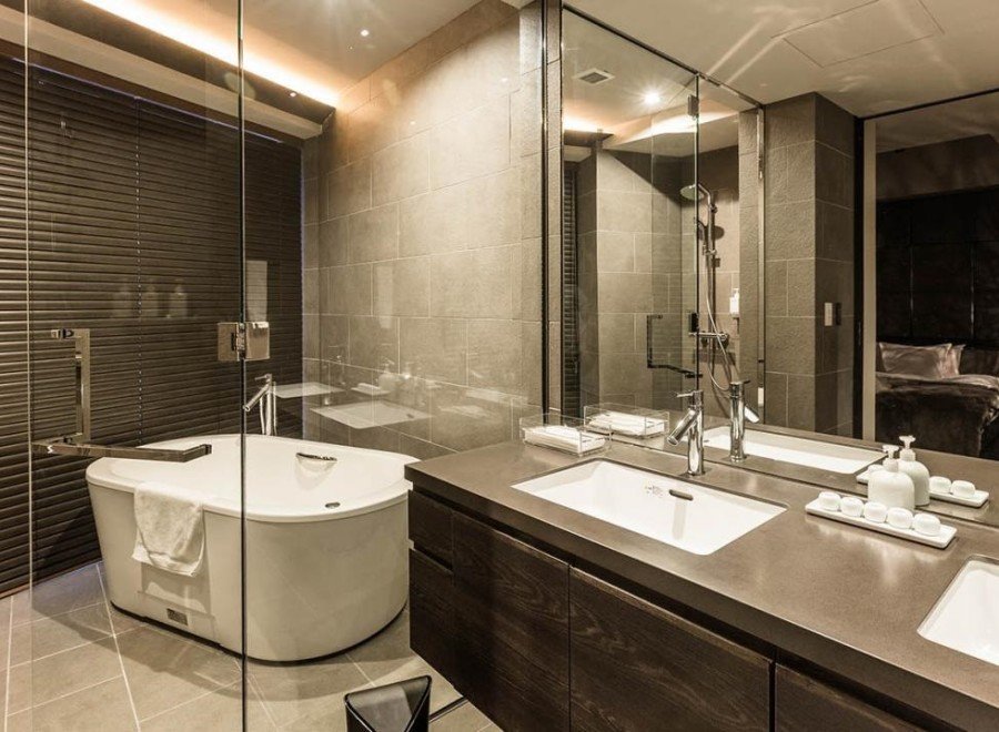 Luxurious bathroom with a freestanding bathtub, double vanity, and glass shower enclosure.