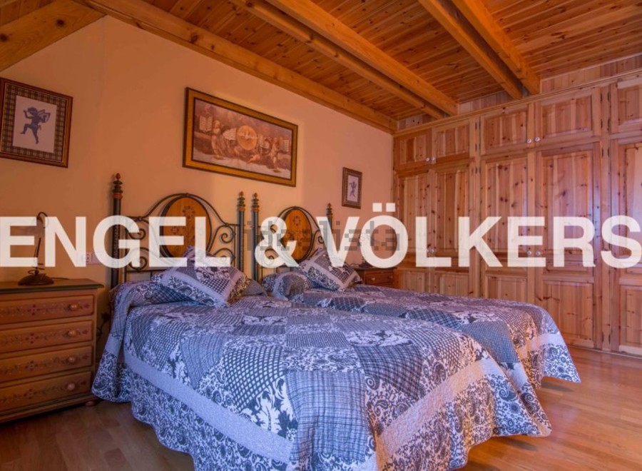 Charming bedroom with twin beds, wooden wardrobe and beamed ceiling.