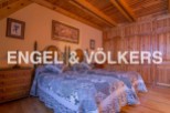 Charming bedroom with twin beds, wooden wardrobe and beamed ceiling.