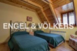 Charming attic bedroom with twin beds, wooden beams, and a cozy atmosphere.