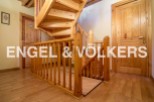 This stunning property boasts a beautiful wooden staircase, adding a touch of elegance to the home.