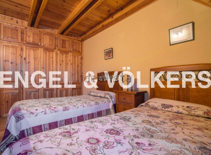 Charming bedroom with wooden built-in wardrobes and twin beds.