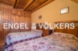Charming bedroom with wooden built-in wardrobes and twin beds.