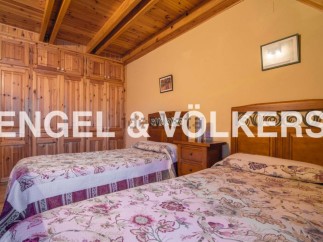 Charming bedroom with wooden built-in wardrobes and twin beds.