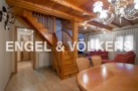 This stunning property boasts a beautiful wooden staircase, high ceilings with exposed wooden beams, and a spacious dining area perfect for entertaining.