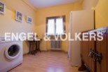 Charming laundry room with vintage sewing machine and ample storage.