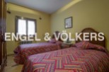 Charming twin bedroom with colorful bedding and wooden headboards.
