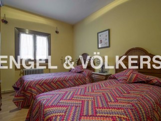 Charming twin bedroom with colorful bedding and wooden headboards.