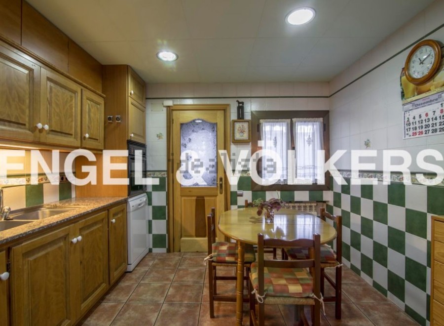 Charming kitchen with wooden cabinets and checkered tile backsplash.