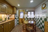Charming kitchen with wooden cabinets and checkered tile backsplash.