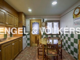 Charming kitchen with wooden cabinets and checkered tile backsplash.