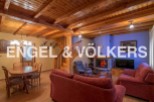 Rustic mountain home with wooden beams, a cozy fireplace, and ample living space.