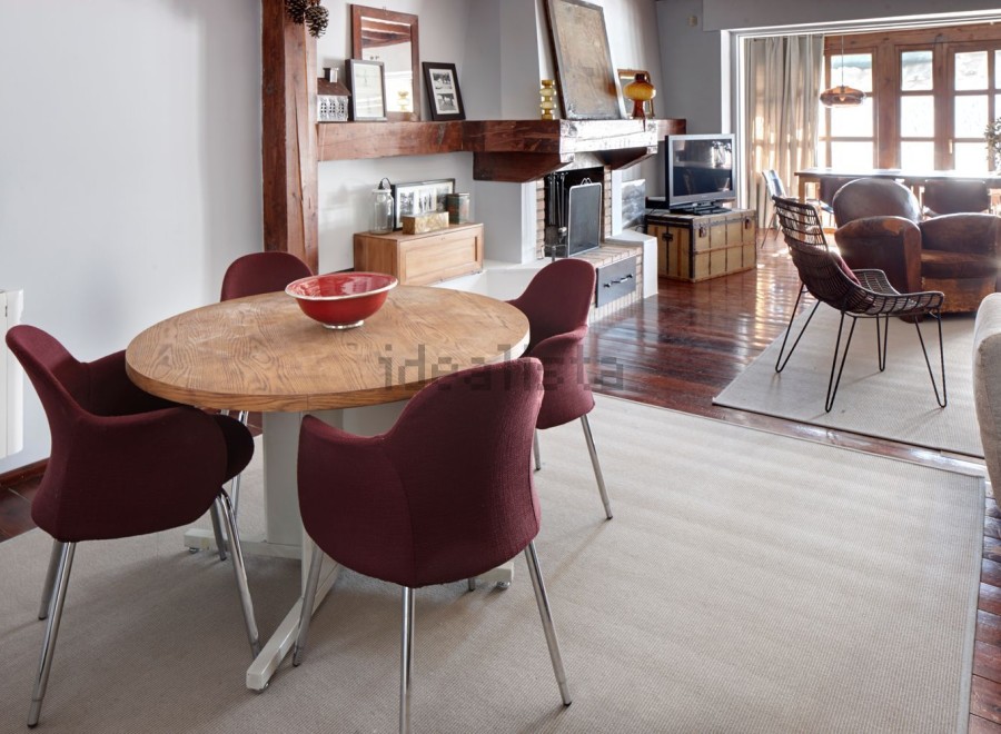 This stunning property boasts a spacious open-plan living area with hardwood floors, a cozy fireplace, and large windows offering abundant natural light.