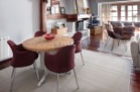 This stunning property boasts a spacious open-plan living area with hardwood floors, a cozy fireplace, and large windows offering abundant natural light.