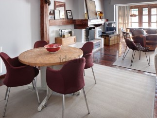 This stunning property boasts a spacious open-plan living area with hardwood floors, a cozy fireplace, and large windows offering abundant natural light.
