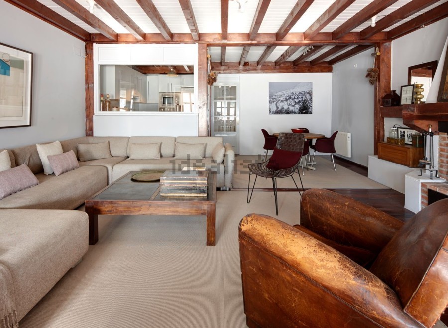 This stunning property boasts a spacious living area with exposed wooden beams, creating a warm and inviting atmosphere.