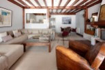 This stunning property boasts a spacious living area with exposed wooden beams, creating a warm and inviting atmosphere.