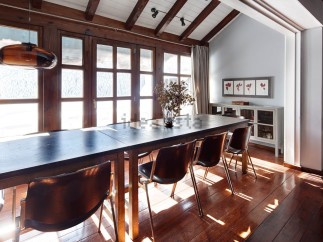 This stunning chalet boasts a spacious dining area with a large wooden table perfect for family gatherings.