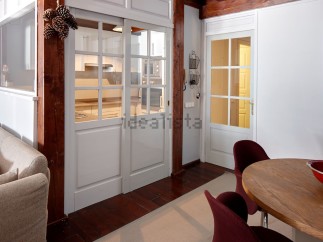 This stunning apartment boasts a unique open-plan living area with a stylish sliding door separating the kitchen and living room.