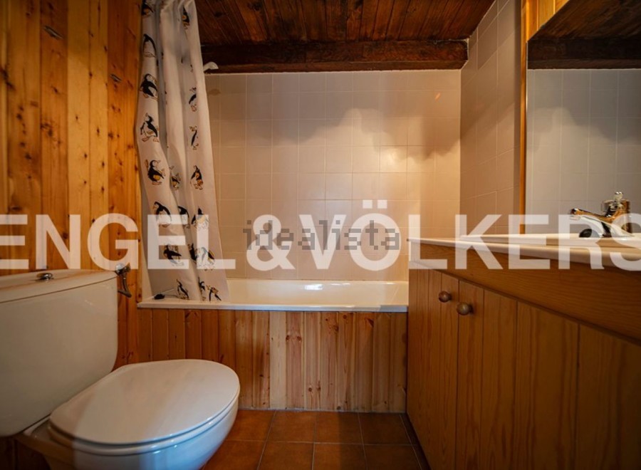 Charming bathroom with wooden finishes and a bathtub.