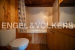 Charming bathroom with wooden finishes and a bathtub.