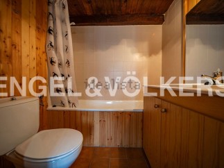 Charming bathroom with wooden finishes and a bathtub.