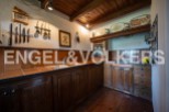 Rustic kitchen with wooden cabinets and countertops, featuring a charming vintage aesthetic.