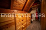 Charming attic room with built-in wooden drawers offering ample storage.