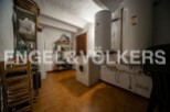 This charming property boasts a spacious laundry room, complete with ample storage shelving and a convenient wine rack.