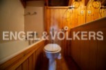 Charming bathroom with wooden finishes and a bathtub.