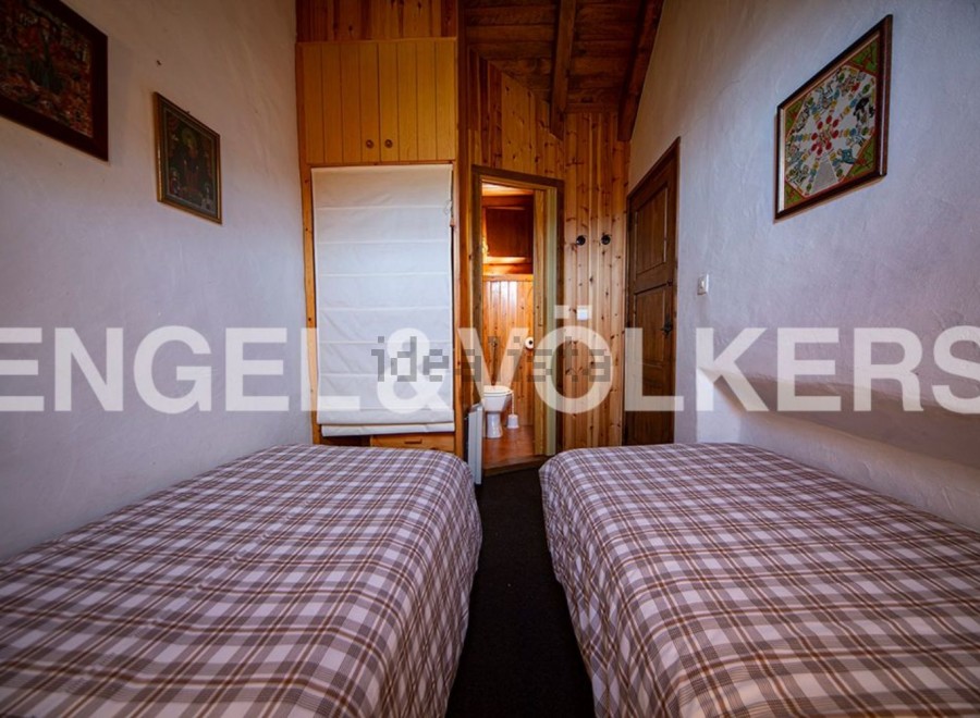 Cozy chalet bedroom with twin beds and plaid bedding.