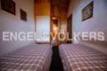 Cozy chalet bedroom with twin beds and plaid bedding.