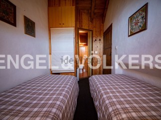 Cozy chalet bedroom with twin beds and plaid bedding.