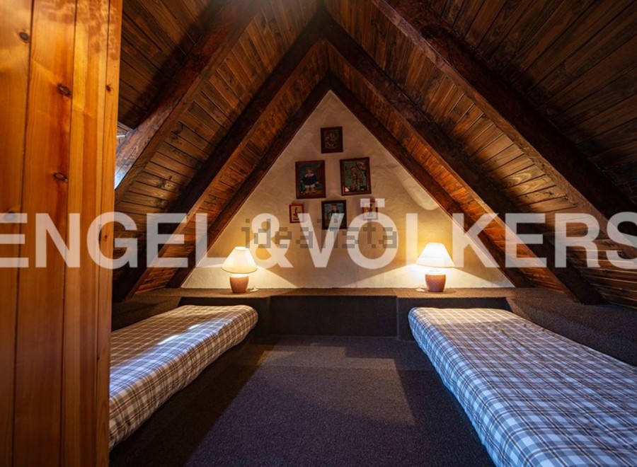 Charming attic room with two twin beds, perfect for children or guests.