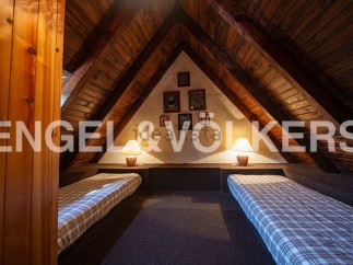 Charming attic room with two twin beds, perfect for children or guests.