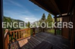 Mountain view chalet with spacious wooden deck.