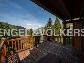 Mountain view chalet with spacious wooden deck.