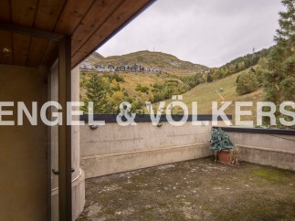 This stunning property boasts a private terrace with breathtaking mountain views.