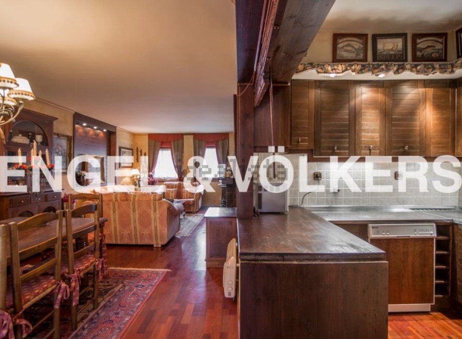 This stunning property boasts a spacious open-plan living area with hardwood floors and a cozy dining setting.