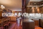 This stunning property boasts a spacious open-plan living area with hardwood floors and a cozy dining setting.