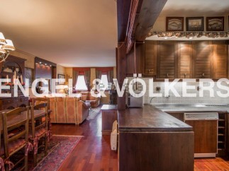 This stunning property boasts a spacious open-plan living area with hardwood floors and a cozy dining setting.