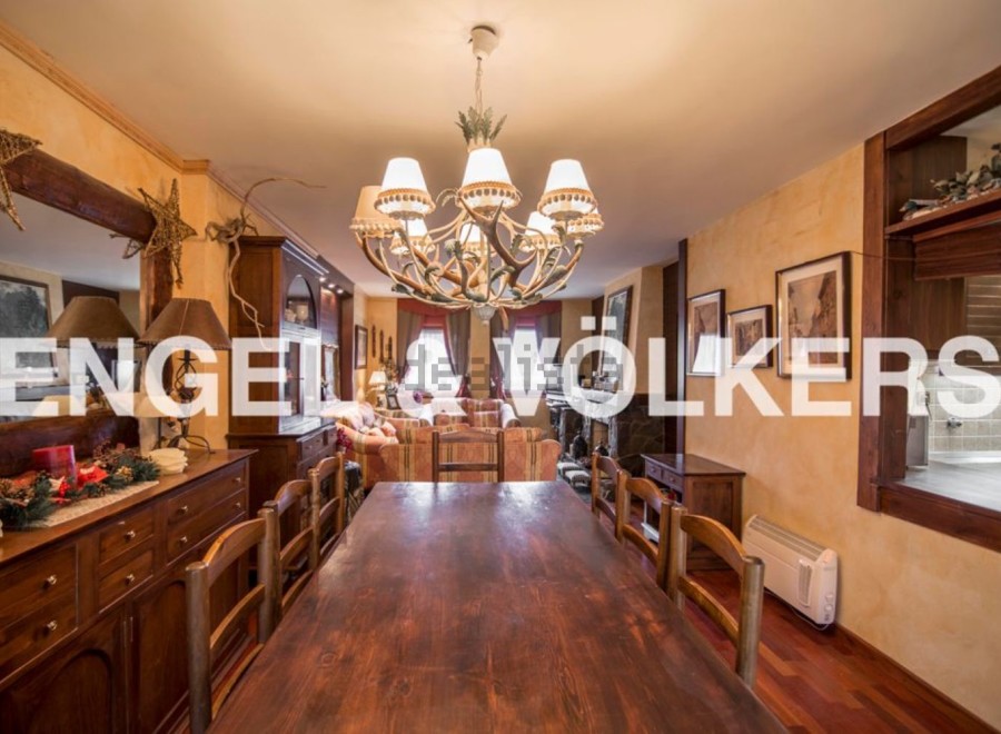 This stunning property boasts a spacious dining area with a large wooden table perfect for family gatherings.