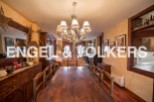 This stunning property boasts a spacious dining area with a large wooden table perfect for family gatherings.