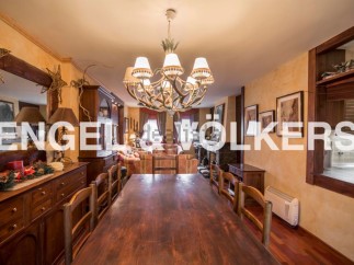 This stunning property boasts a spacious dining area with a large wooden table perfect for family gatherings.