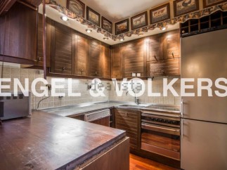 Charming kitchen with rustic wooden cabinetry and stainless steel countertops.