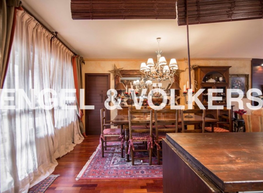 This stunning property boasts a spacious dining room with hardwood floors, an ornate chandelier, and large windows that let in plenty of natural light.