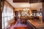 This stunning property boasts a spacious dining room with hardwood floors, an ornate chandelier, and large windows that let in plenty of natural light.