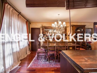 This stunning property boasts a spacious dining room with hardwood floors, an ornate chandelier, and large windows that let in plenty of natural light.