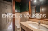 This stunning bathroom boasts a spacious shower, modern sink, and elegant toilet.